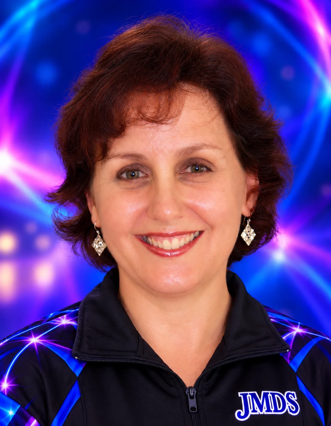 Julia Macalpine, principal of JMDS, smiling in a JMDS team jacket